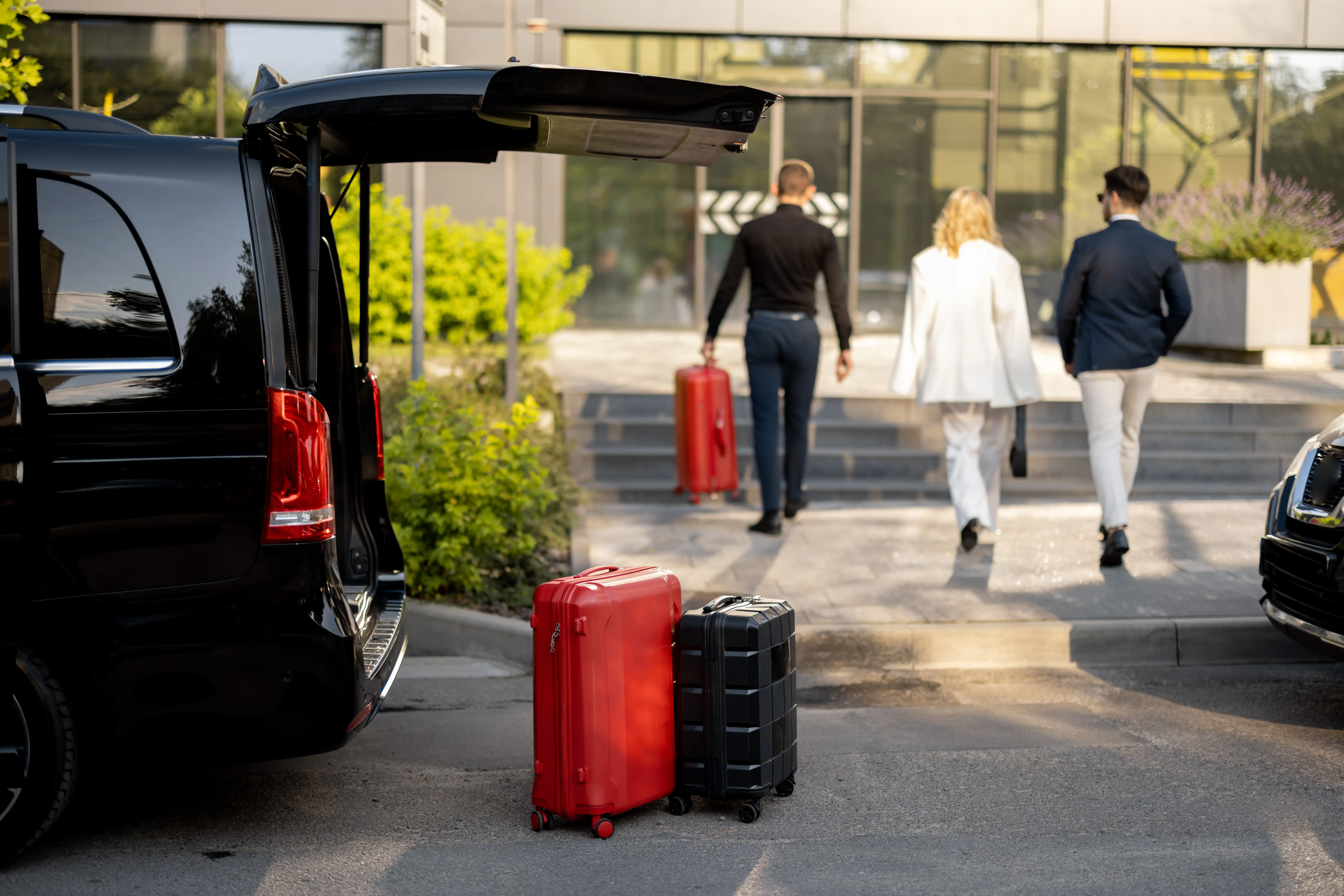 Private transfer van with luggage outside a hotel entrance