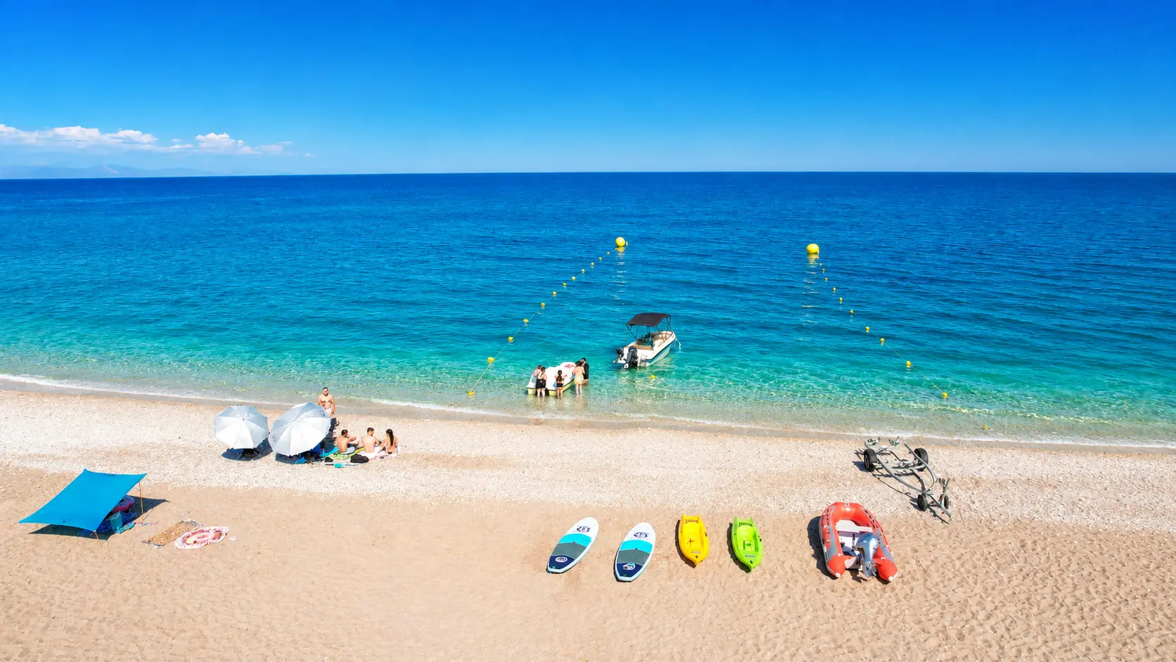 Aerial view over the Riptide kiosk and shoreline at Afandou Beach