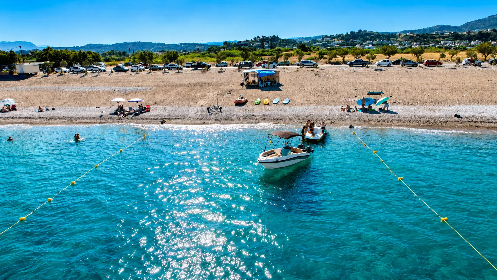 Aerial shoreline view of Afandou Beach and clear blue water