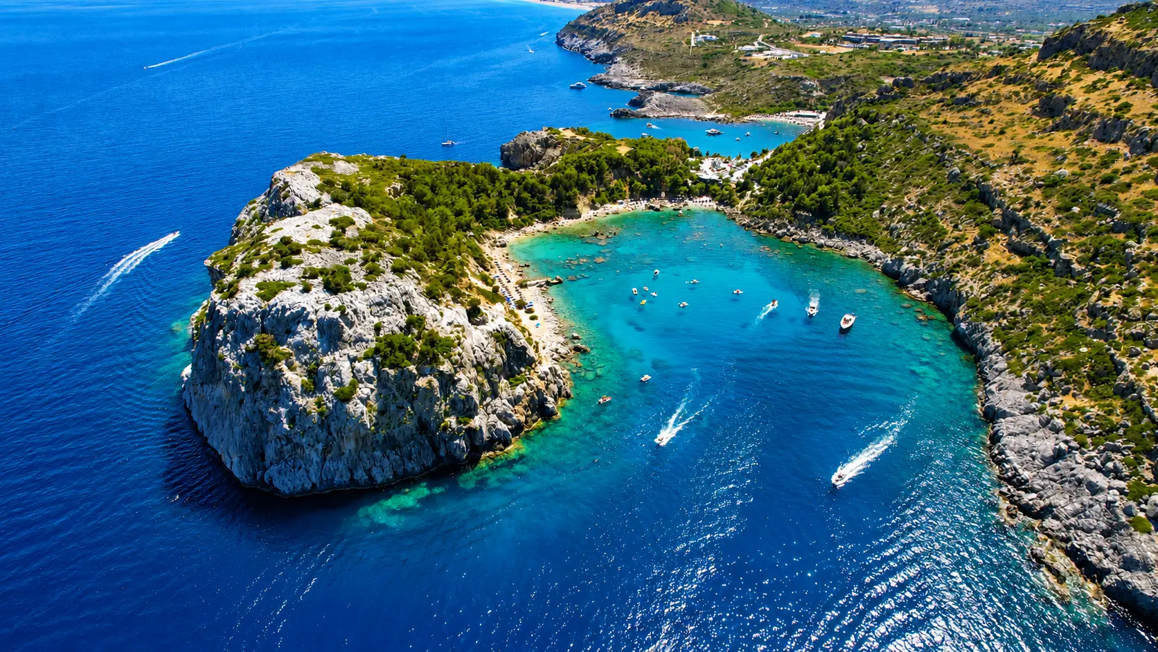 Wide aerial view of Anthony Quinn Bay and the surrounding Rhodes coastline