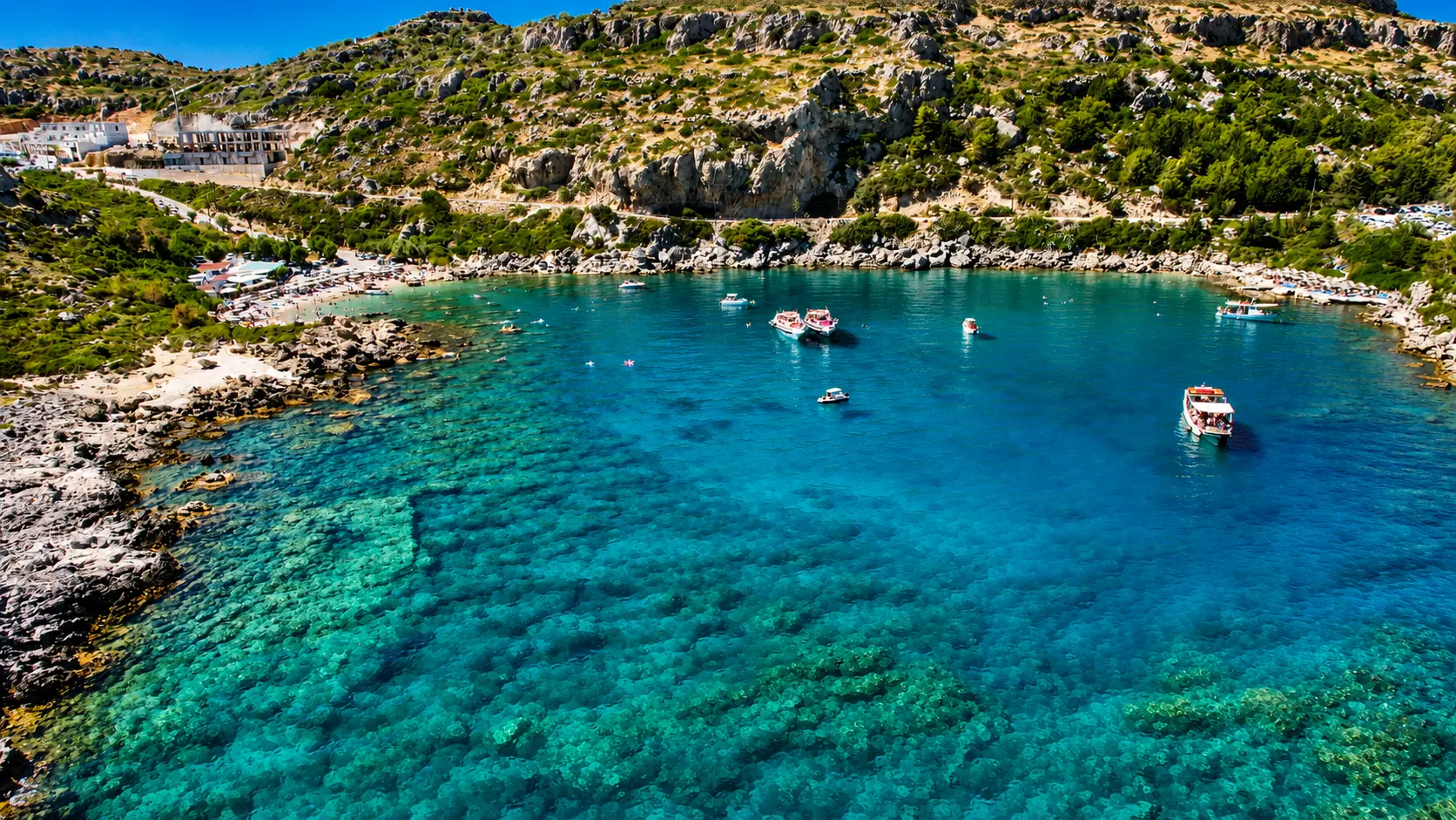 Ladiko Bay sheltered turquoise water and rocky shoreline in Rhodes